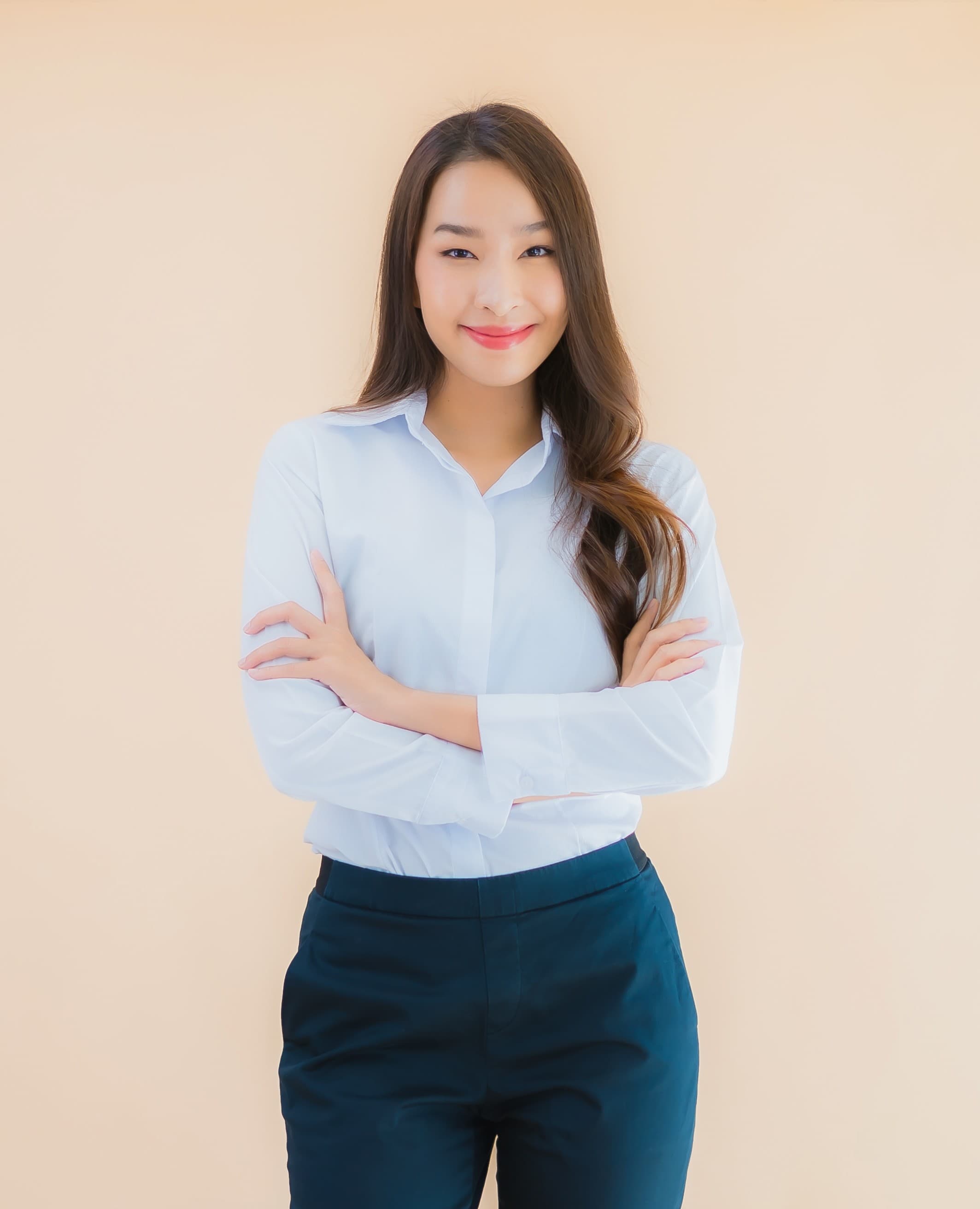 Smiling business professional with arms crossed