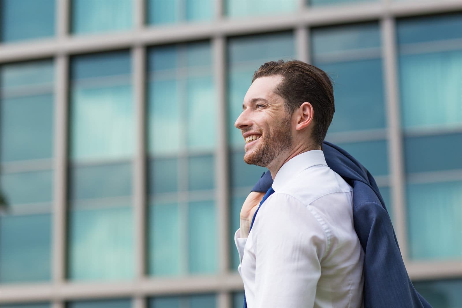 Smiling professional outside a modern office building